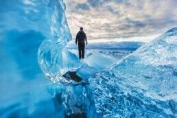 man standing on top of glacier