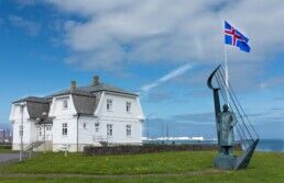 hofdi house behind the iceland flag